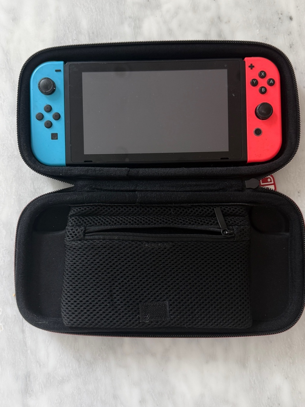 Nintendo Switch with Neon Blue & Neon Red Joy‑Con in Travel Case